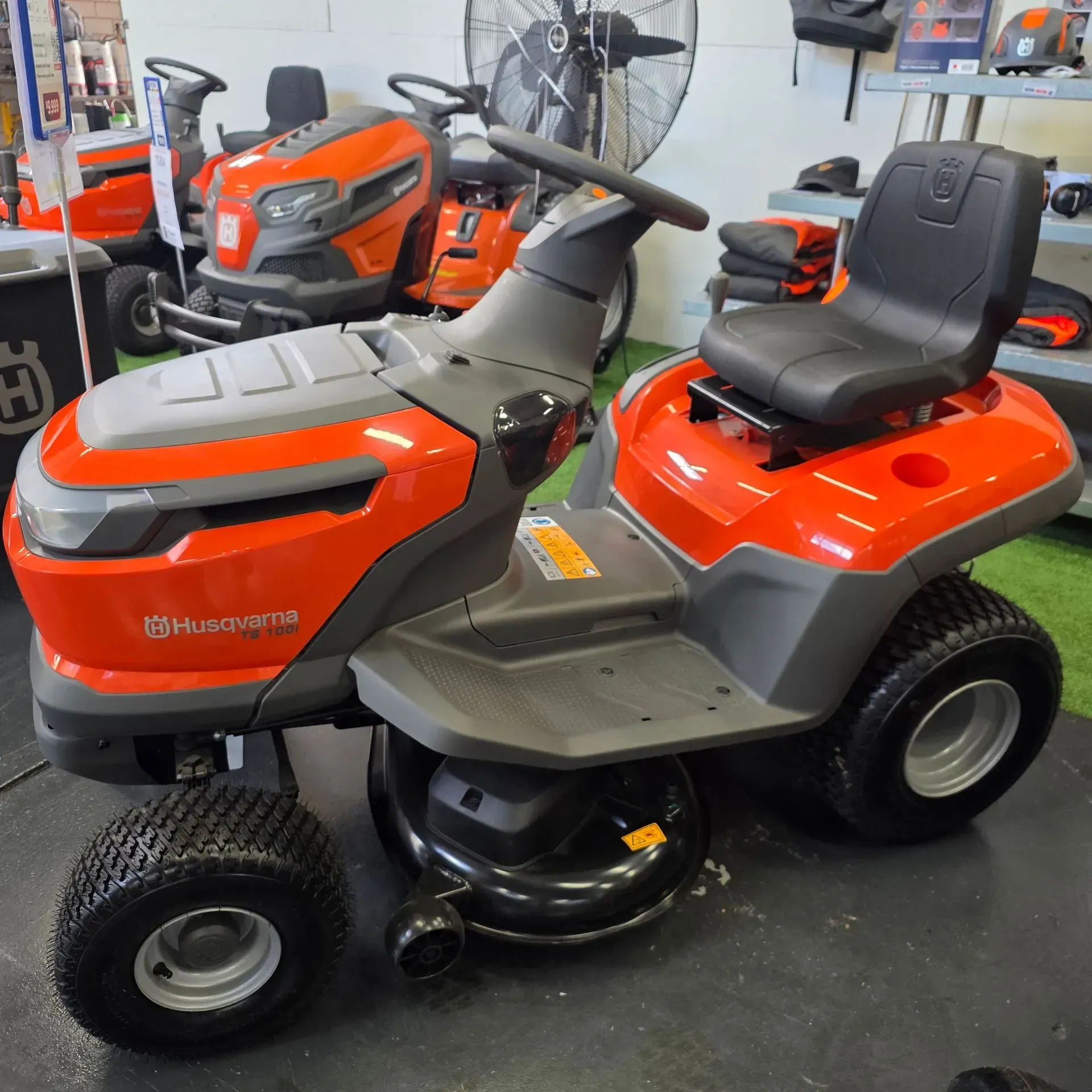 Orange and Gray Riding Lawn Tractor in a Shop — Lift It Equipment in Tuggerah, NSW