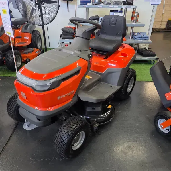 Orange Riding Lawn Mower in a Workshop Showroom — Lift It Equipment in Tuggerah, NSW