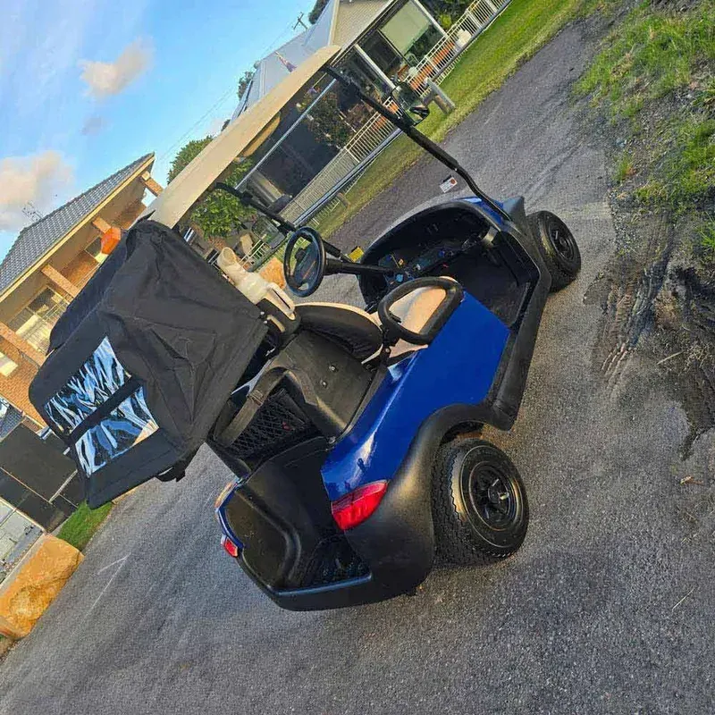 Blue and Black Golf Cart Parked on a Gravel Lot — Lift It Equipment in Tuggerah, NSW