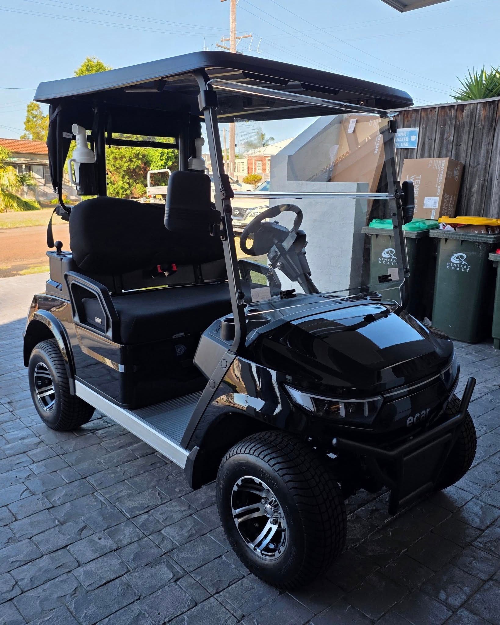 Black Golf Cart With Roof and Four Seats Parked on a Driveway — Lift It Equipment in Tuggerah, NSW