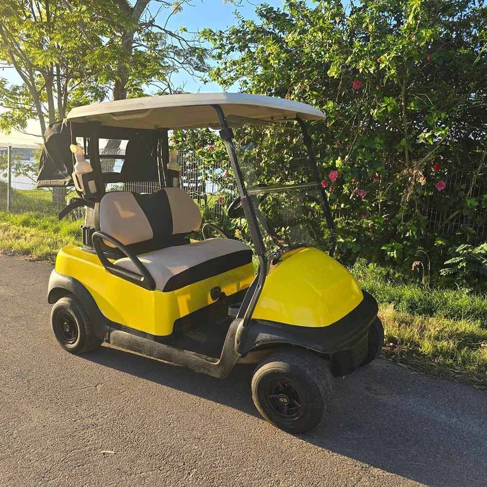 Yellow Golf Cart Parked on a Road Beside Greenery — Lift It Equipment in Summerland Point, NSW