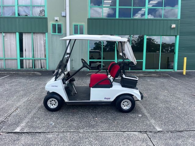 White Golf Cart With Red Seats Parked Outside a Building With Green Windows — Lift It Equipment in Tuggerah, NSW