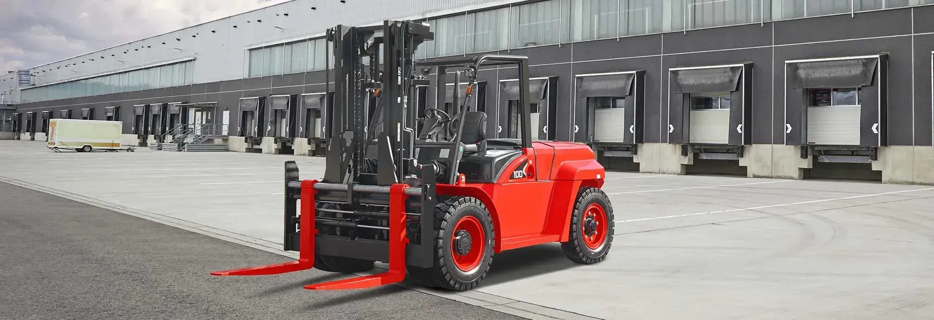 Red Forklift Parked in Front of a Row of Warehouse Loading Docks — Lift It Equipment in Tuggerah, NSW
