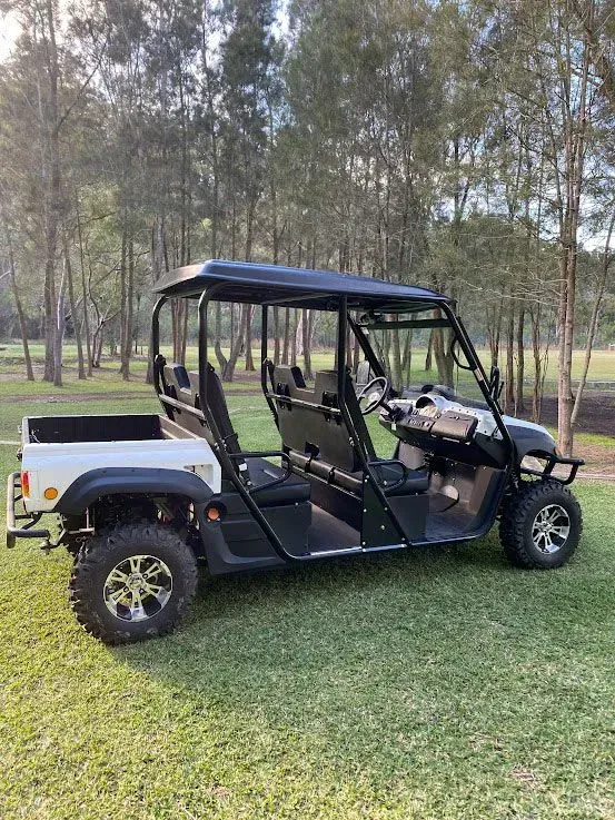 Black Off-road Utility Cart Parked on Grass in a Wooded Area — Lift It Equipment in Summerland Point, NSW