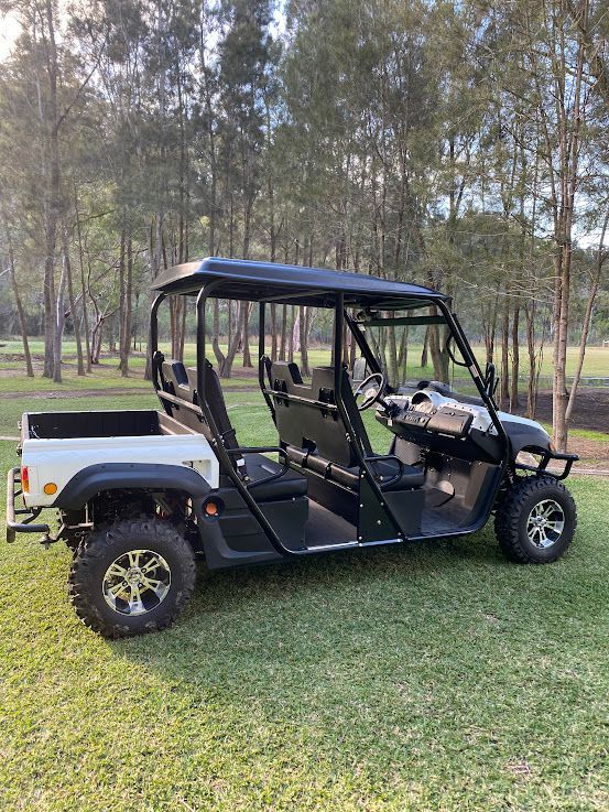 Black Utility Golf Cart Parked on Grass With Trees — Lift It Equipment in Summerland Point, NSW