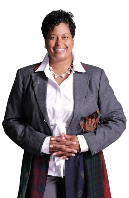 Woman in a gray blazer and white blouse, smiling with hands clasped, holding a patterned scarf.