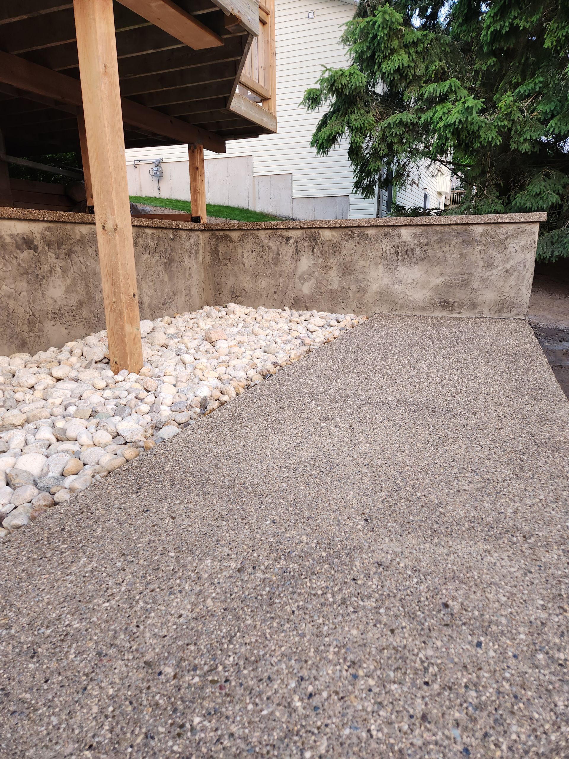 A concrete walkway leading to the front door of a house