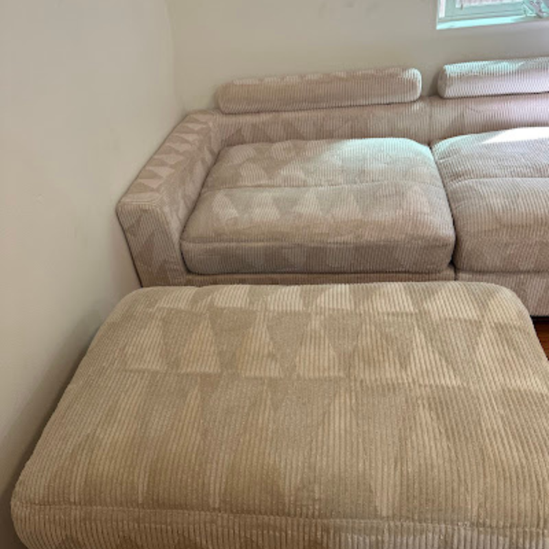 Image of a tan sofa and foot rest that has been recently cleaned
