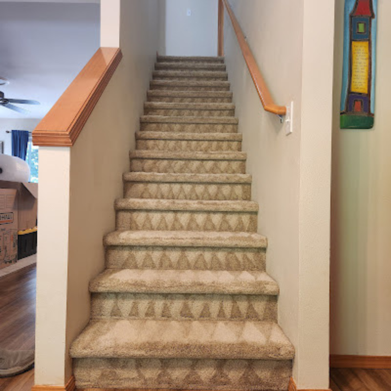 Image of a tan staircase with carpet that has been cleaned