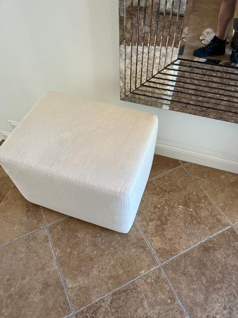 Image of an upholstery foot rest on a marble floor