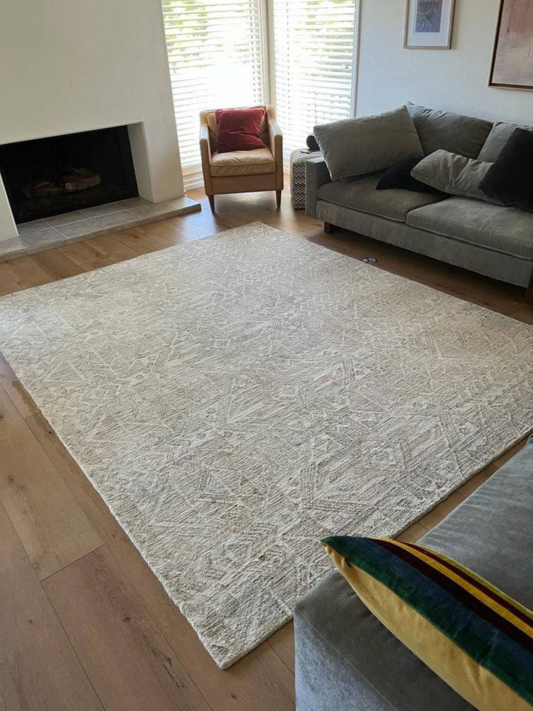 Photo of a living room with hardwood floor and recently cleaned floor rug