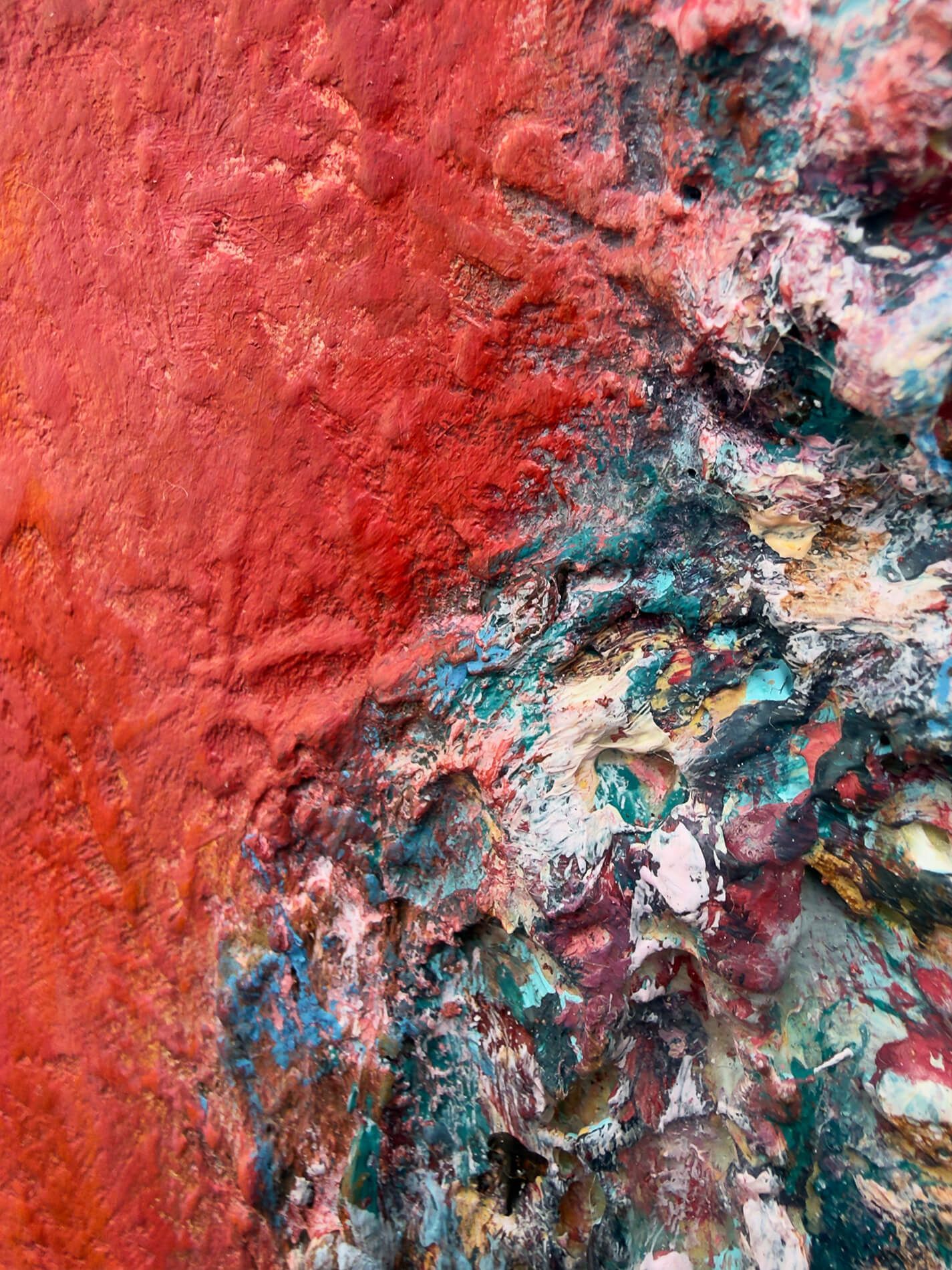 Close-up of the central figure emerging from the textured red surface of After the Fire