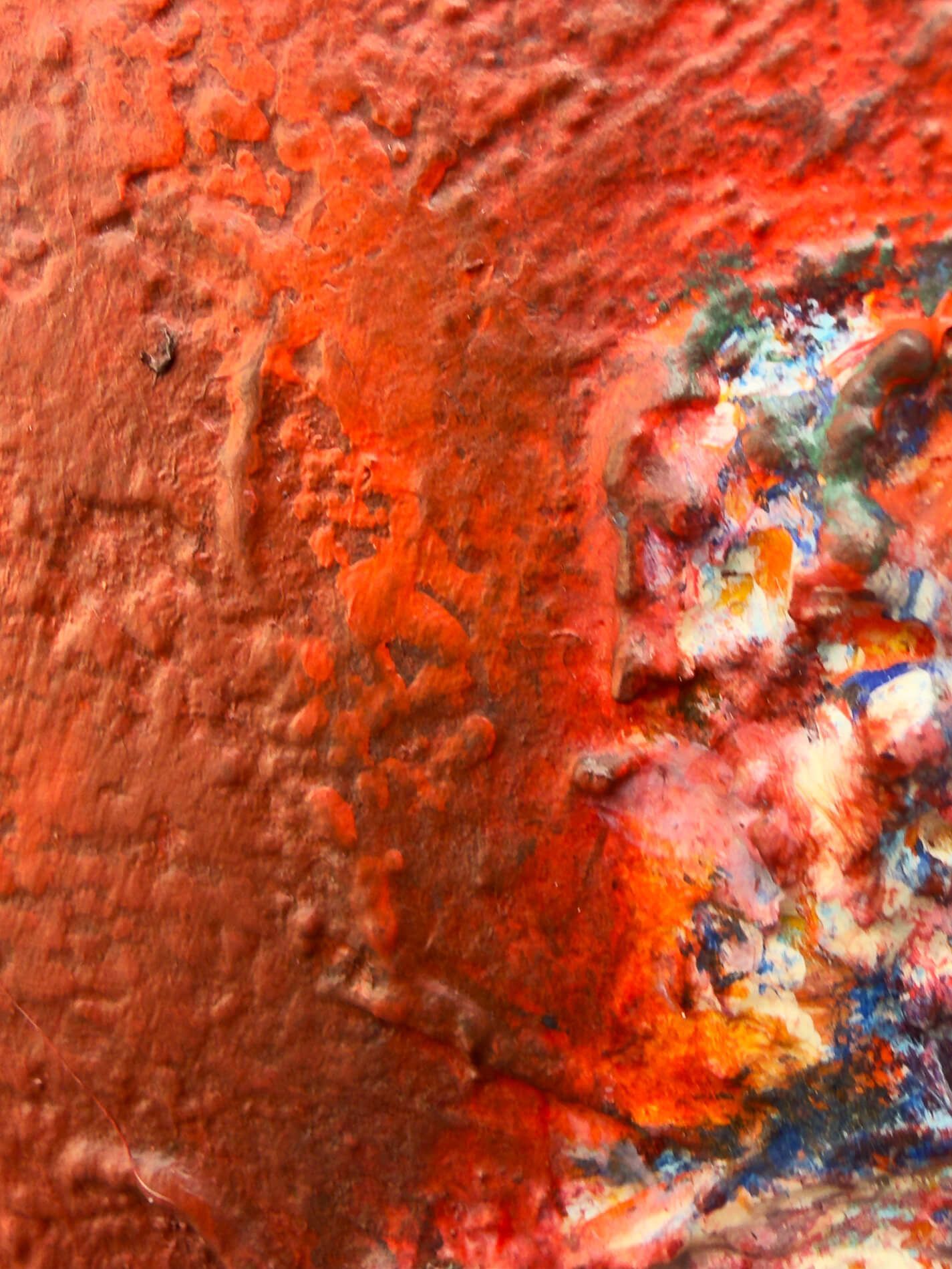 Close-up of the solitary figure emerging from the textured red surface of Gathered in Passing