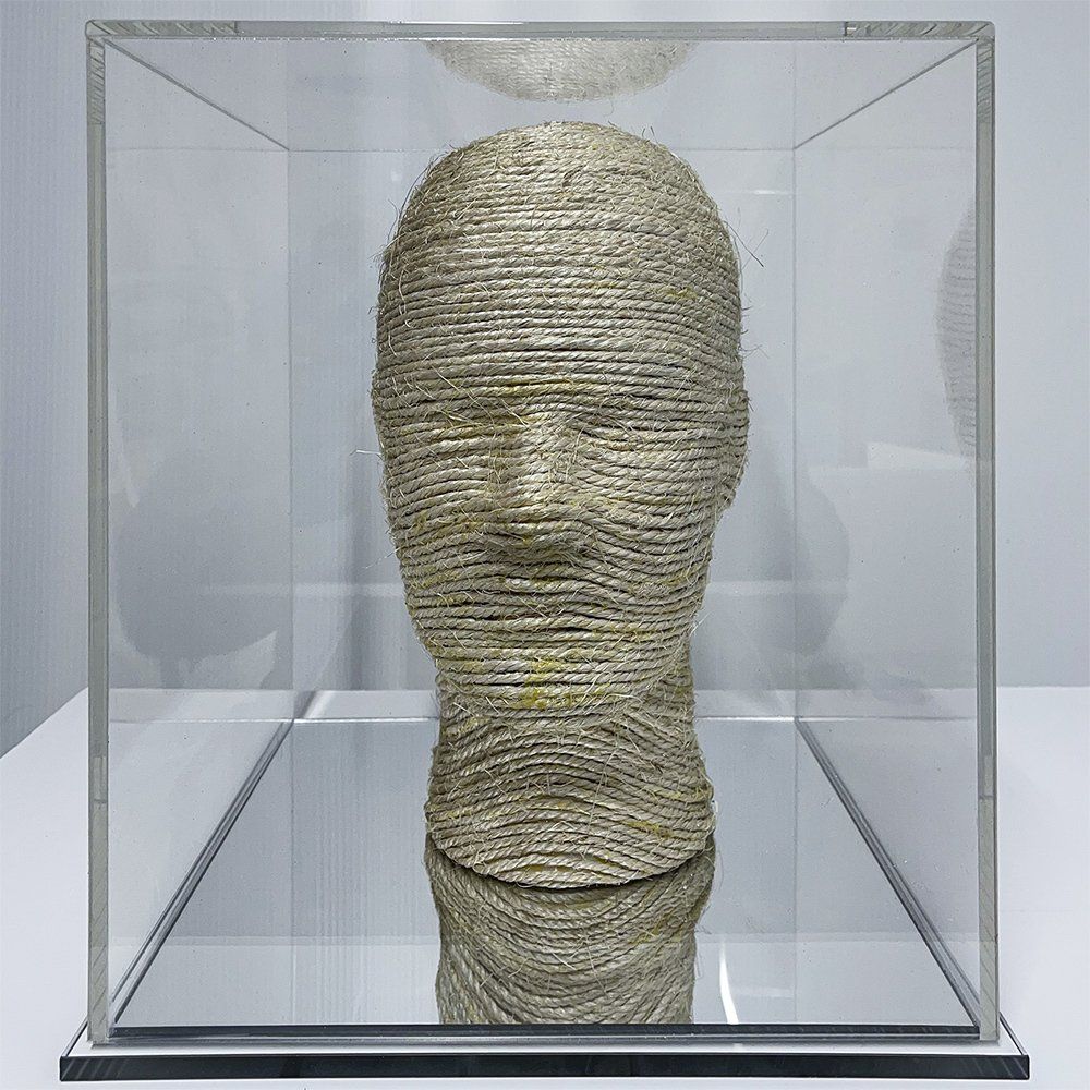 You I Am - Old mannequin head wrapped in sisal, encased in a clear acrylic box with a mirrored base