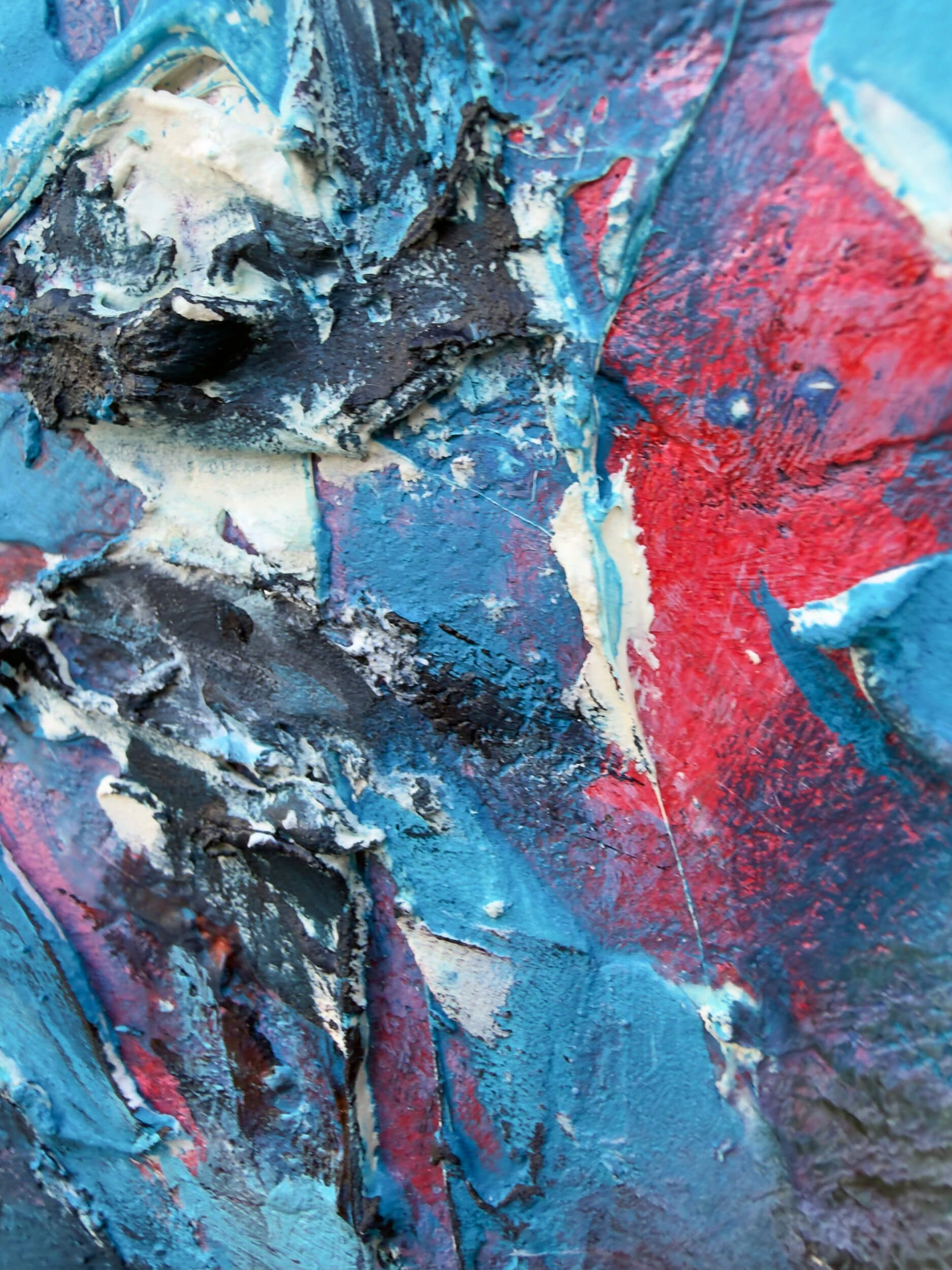 Close-up of blue, red and white acrylic, silicone and mesh within the fractured central figure