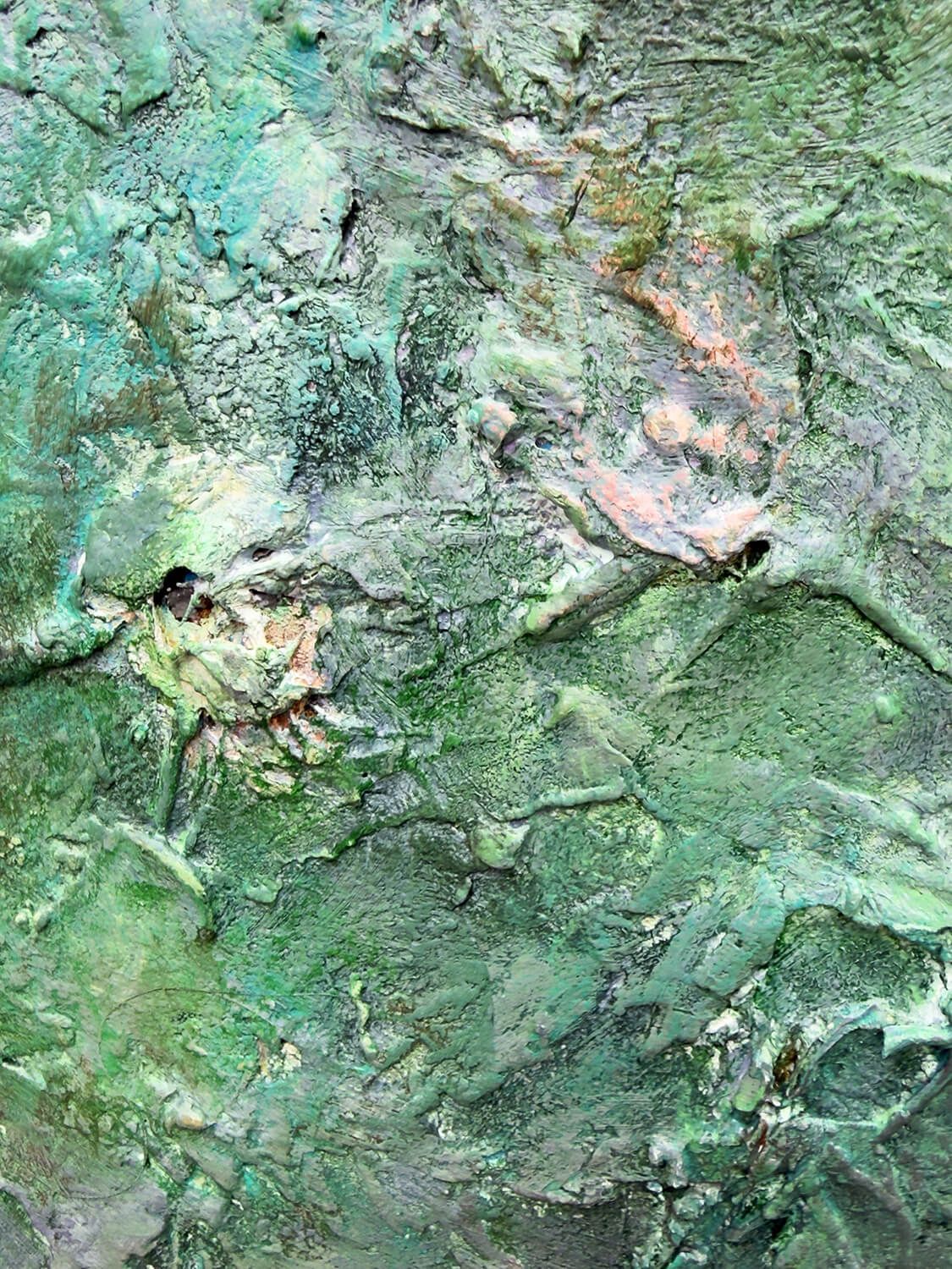 Concealed skull-like form within layers of green plaster and paint in Relic of the Divided Self