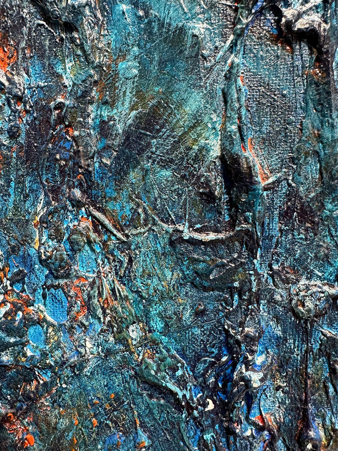 Surface detail of The Ancestors showing fragmented forms, embedded materials and flashes of orange within dark blue and turquoise paint.