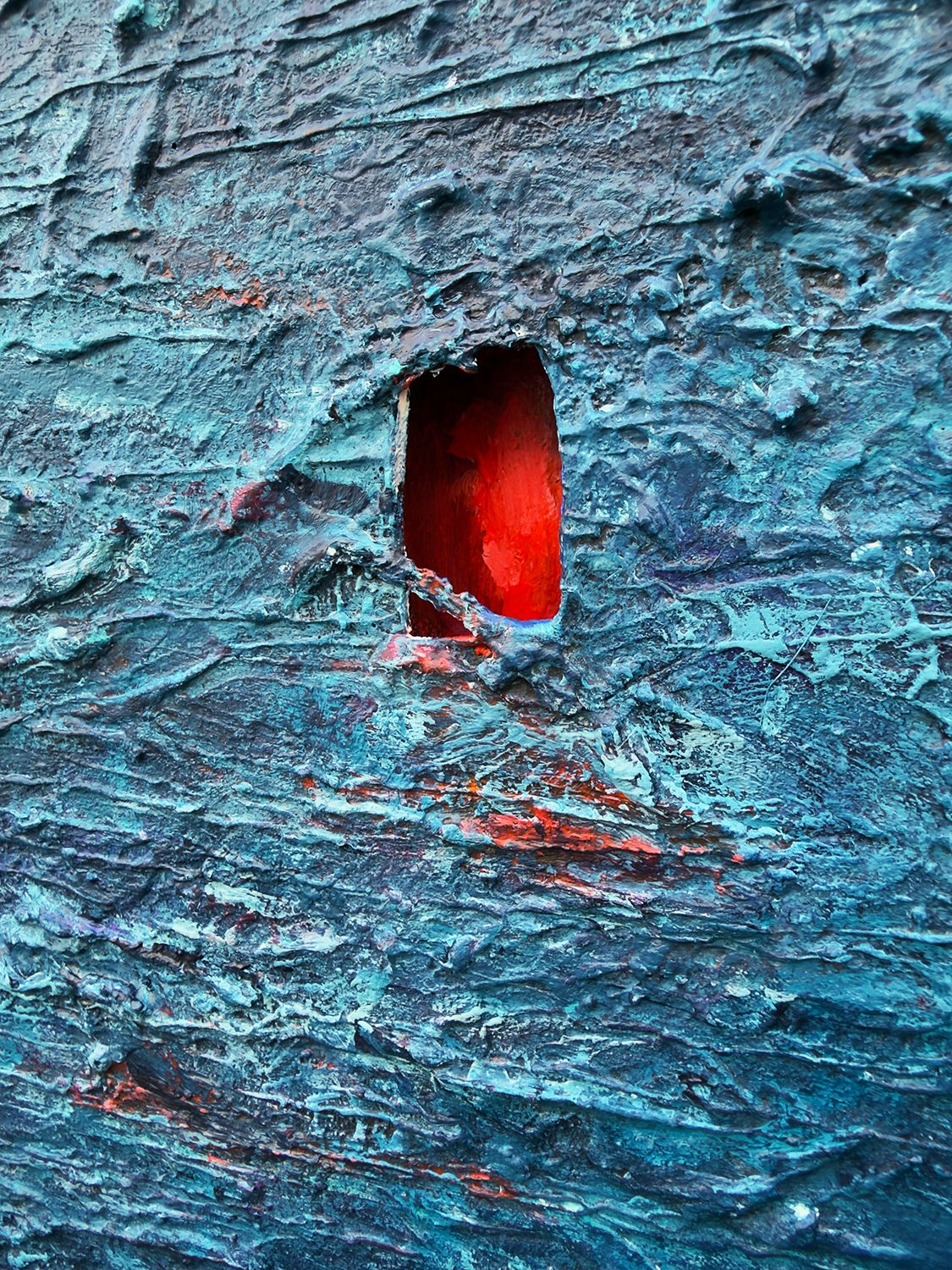 Angled detail showing the depth of the red recess cut into the textured surface of The Lie Was the Door.