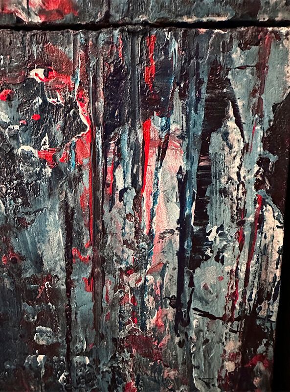 detail view of painting textures in Prussian blue, red and white