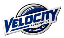 Velocity Automotive logo with blue text and a black-and-silver circular emblem, Burbank, CA