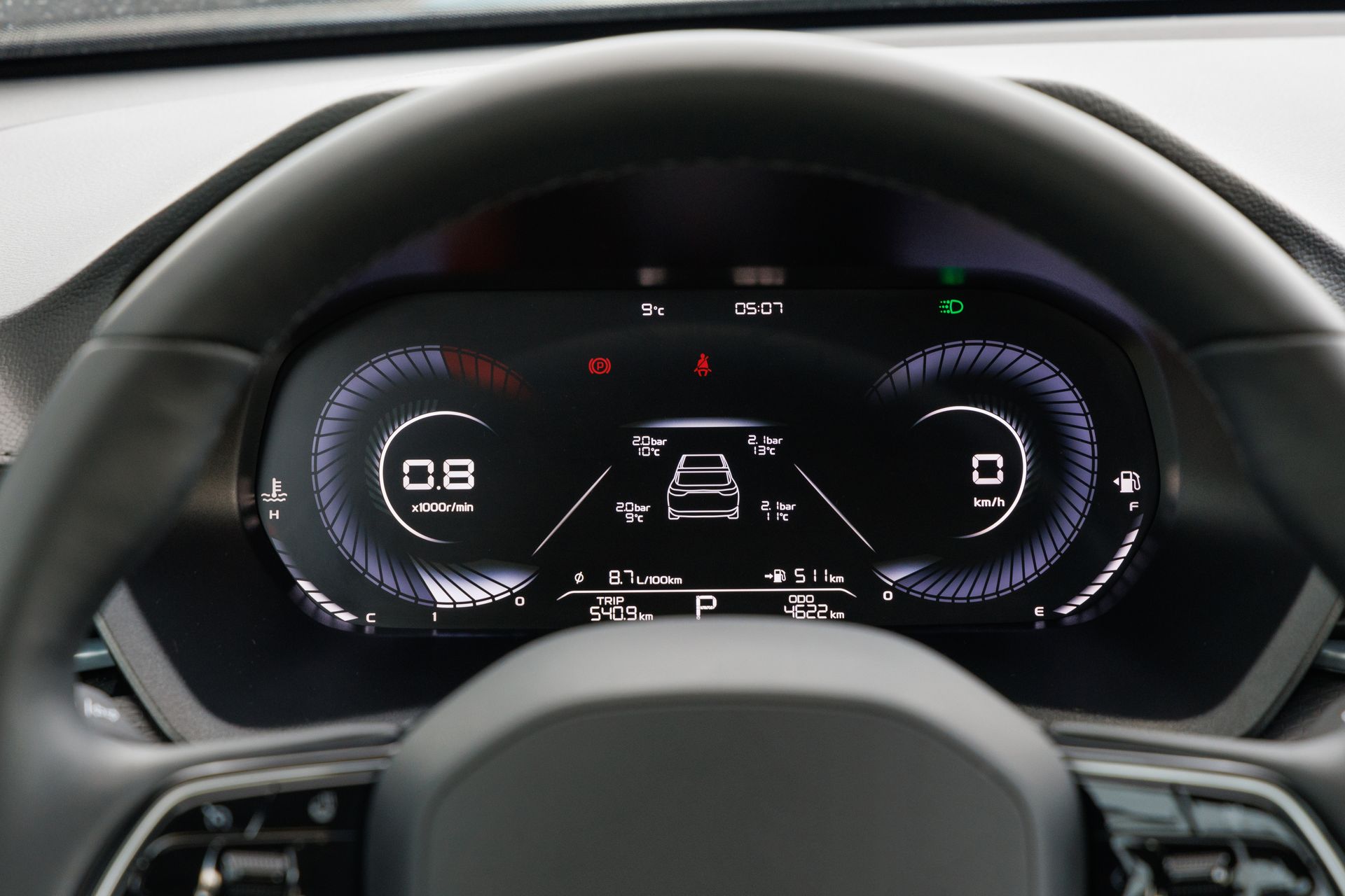 Car dashboard digital instrument cluster showing speed, gear, and lane assist indicators