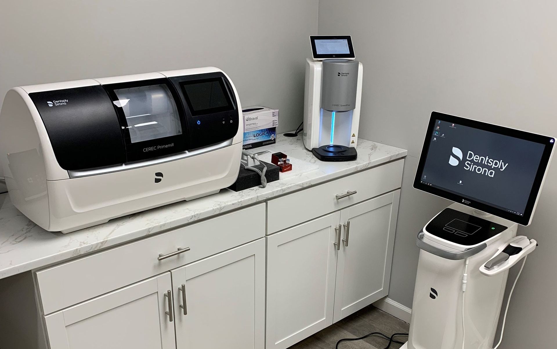 Lab equipment on a countertop beside a computer monitor in a clinical workspace