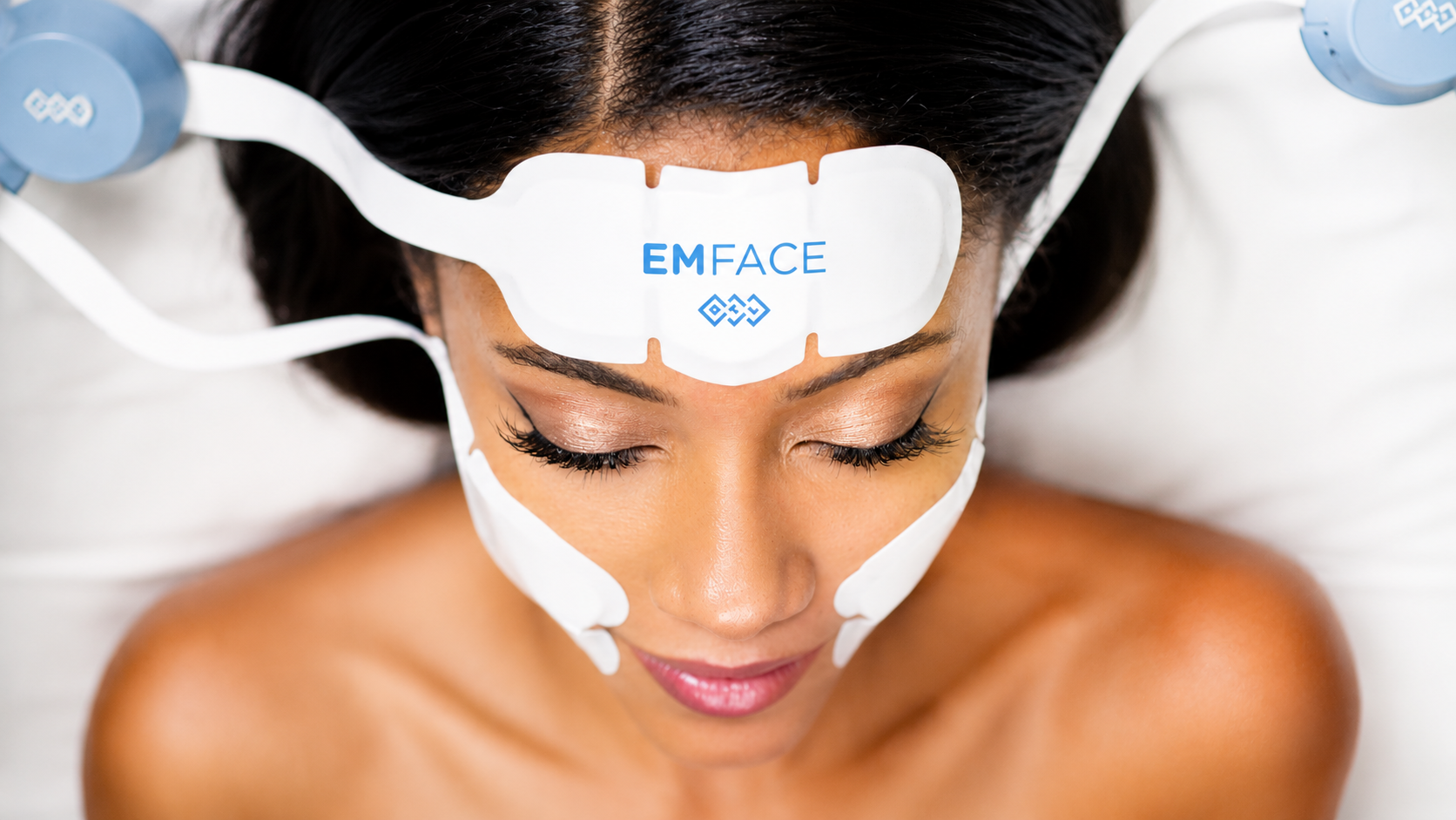 Person sleeping with a white EMFACE device attached to the cheek and temple.