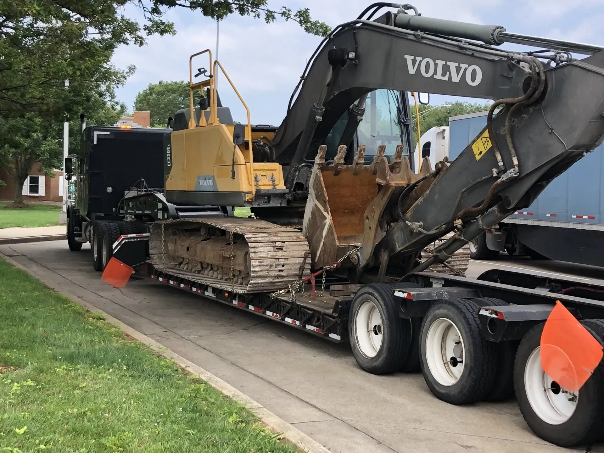 Heavy Trailer With Backhoe | Viroqua, WI | Bruce Hill, LLC