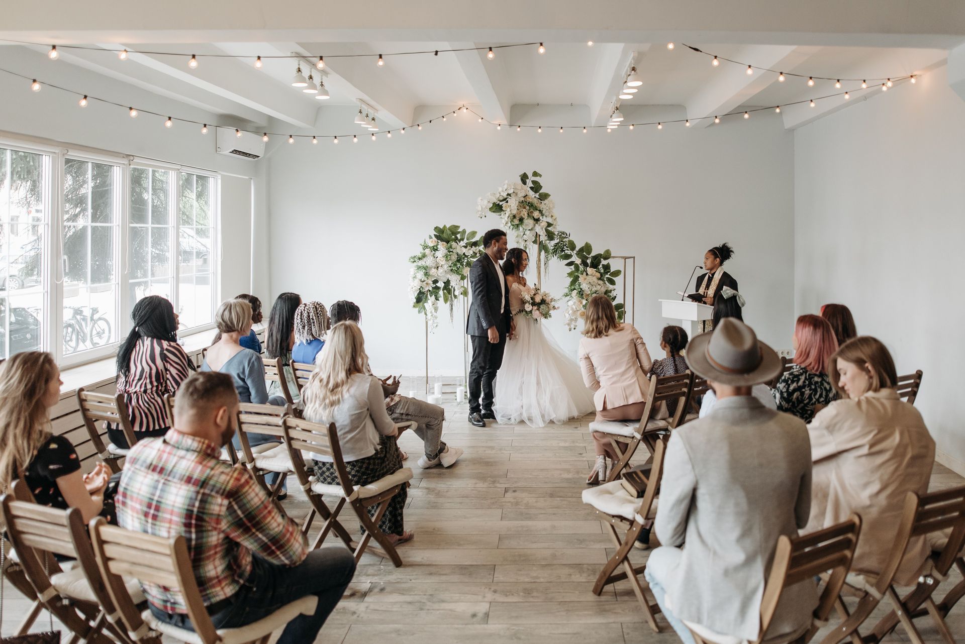 Small intimate wedding ceremony with guests seated and officiant at front