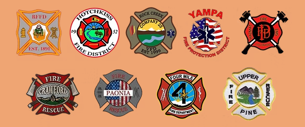 Collage of multiple colorful fire department-style badges and emblems on a peach background.