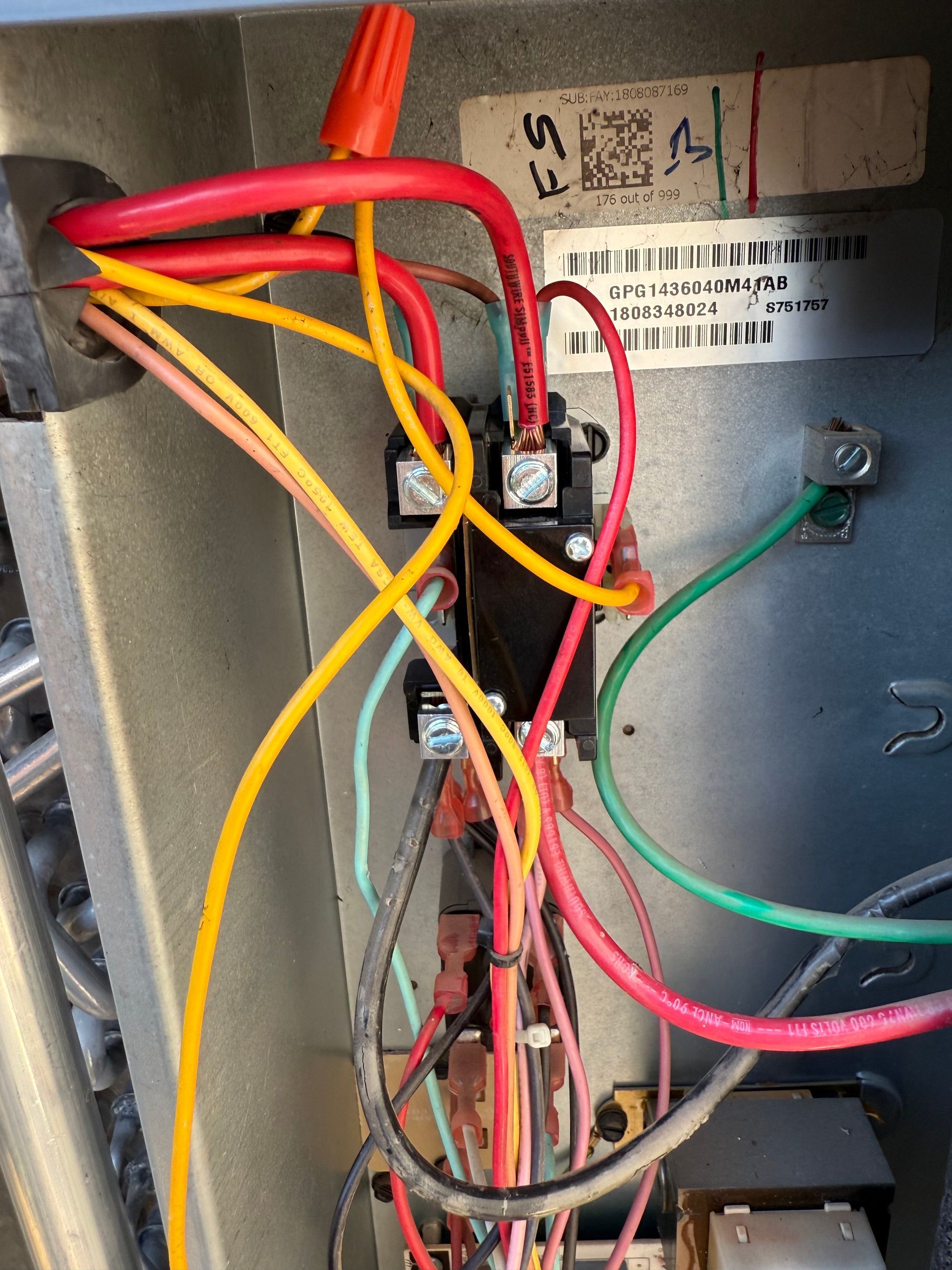 A bunch of wires are connected to a box with a label on it