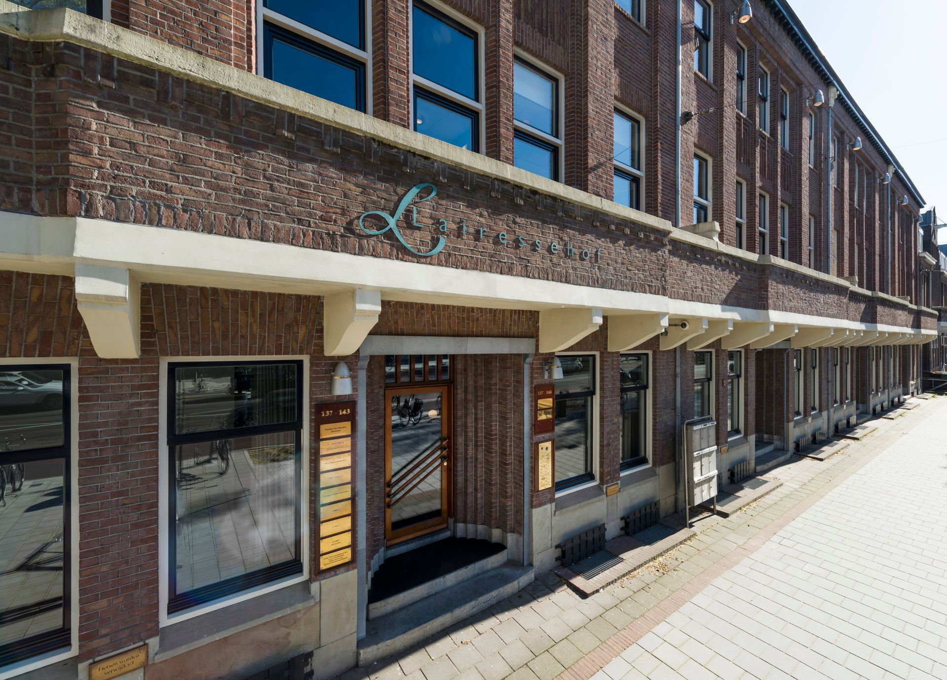 A large brick building with a lot of windows and a door.