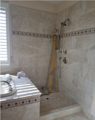 A bathroom with a shower and a yellow level