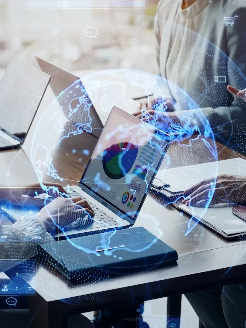 Business meeting with laptops and digital blue data graphics over a conference table