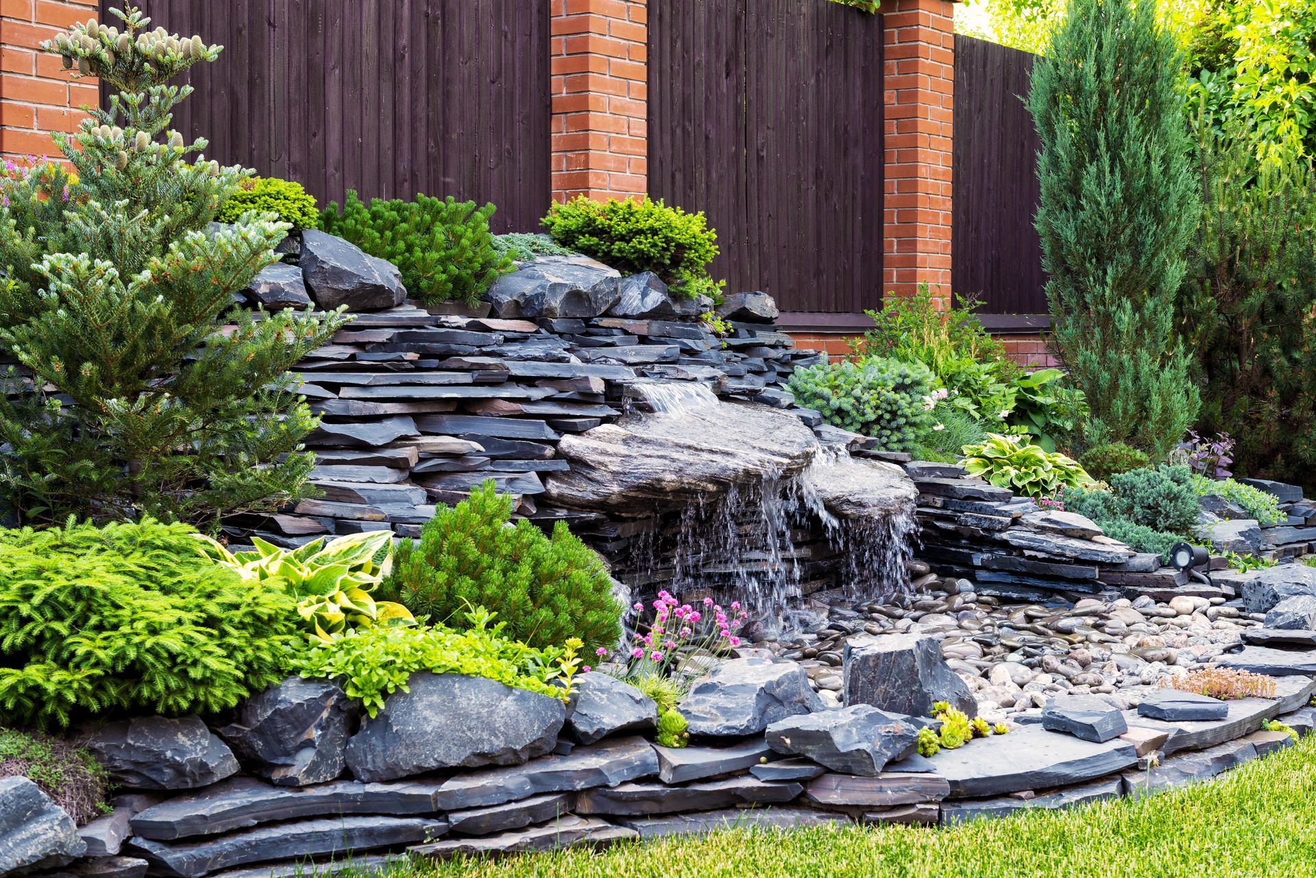 There is a waterfall in the middle of the garden.