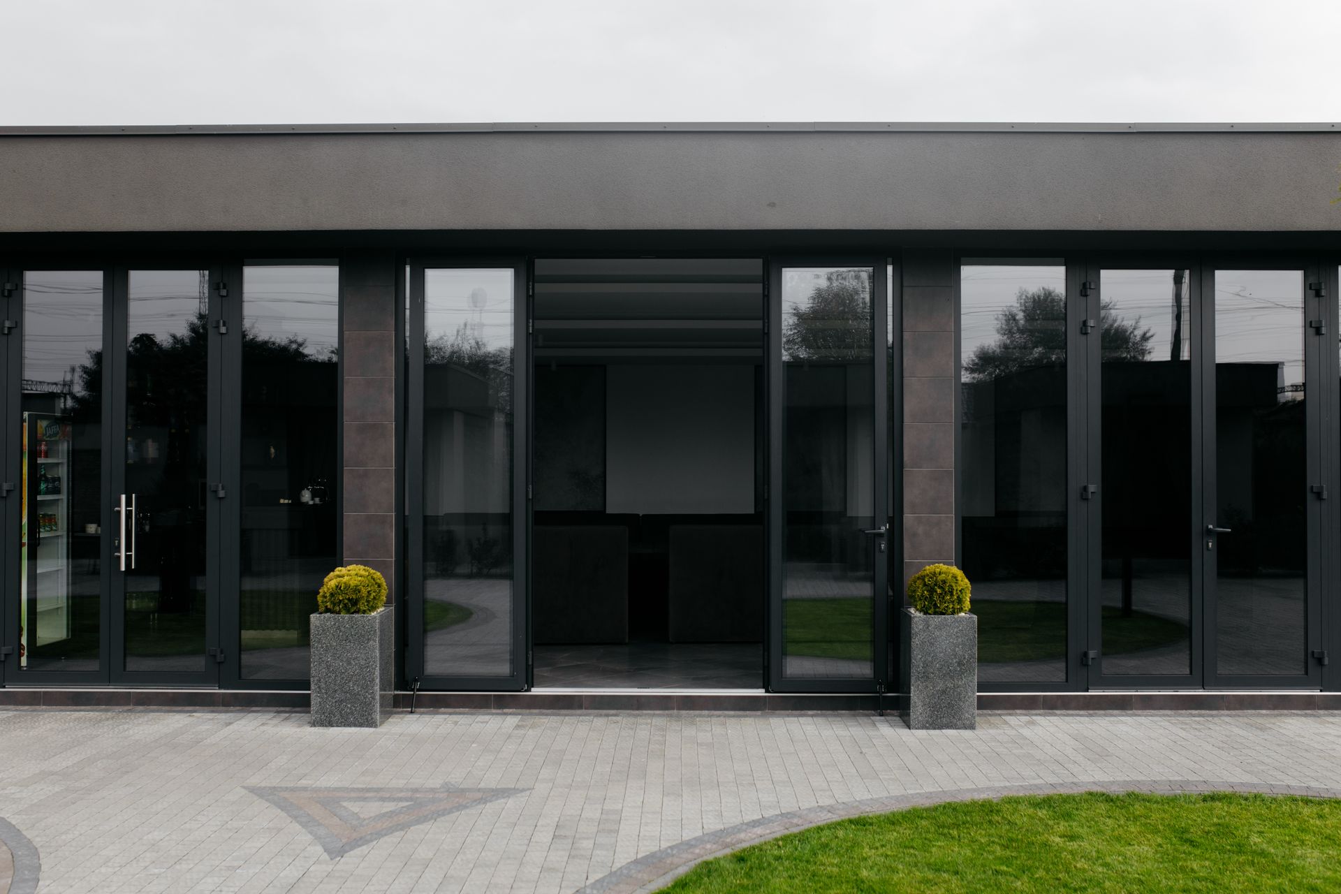 A modern house with a lot of windows and doors.