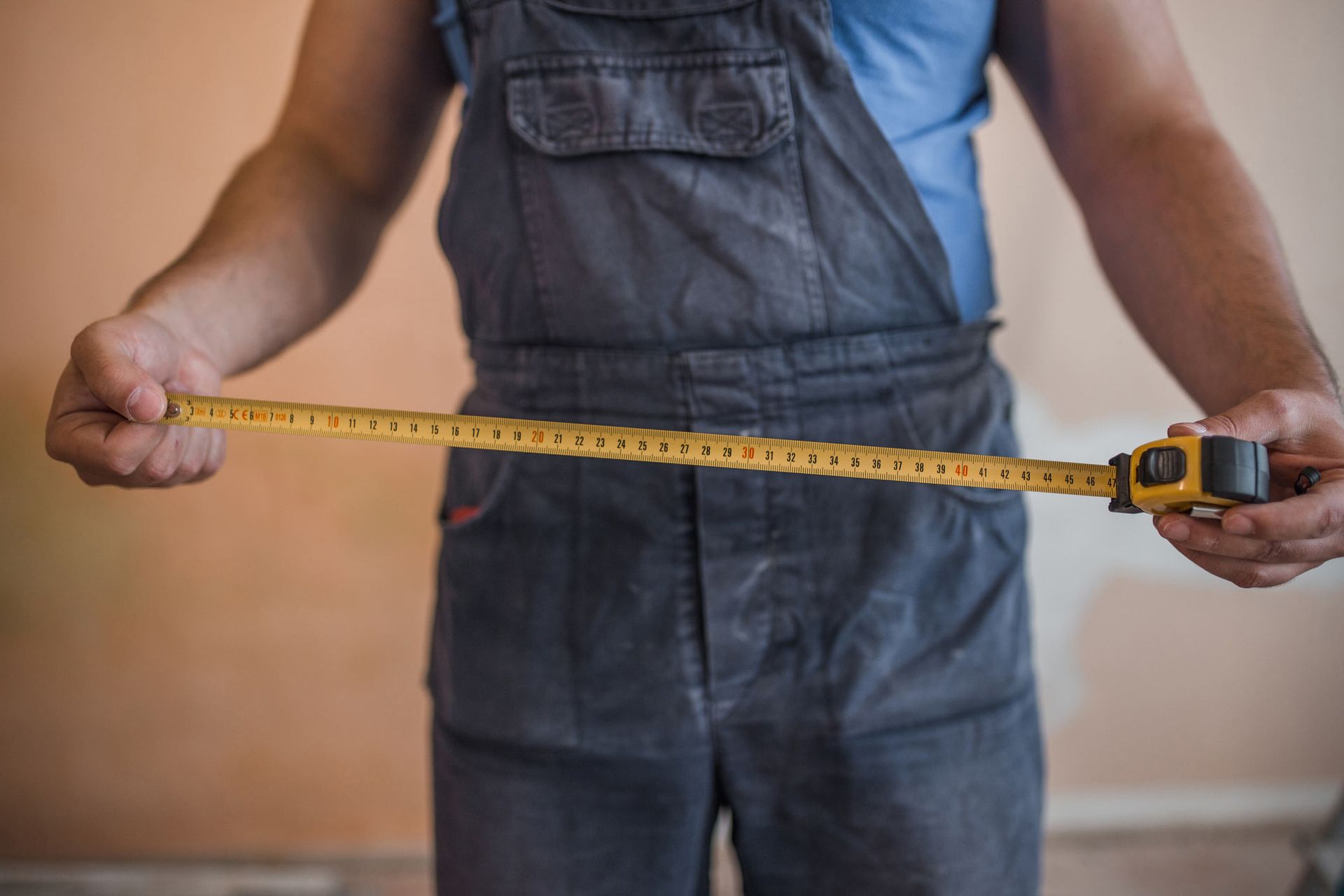 Man holding a tape measure | Adelaide, SA | Shopfitting Industries