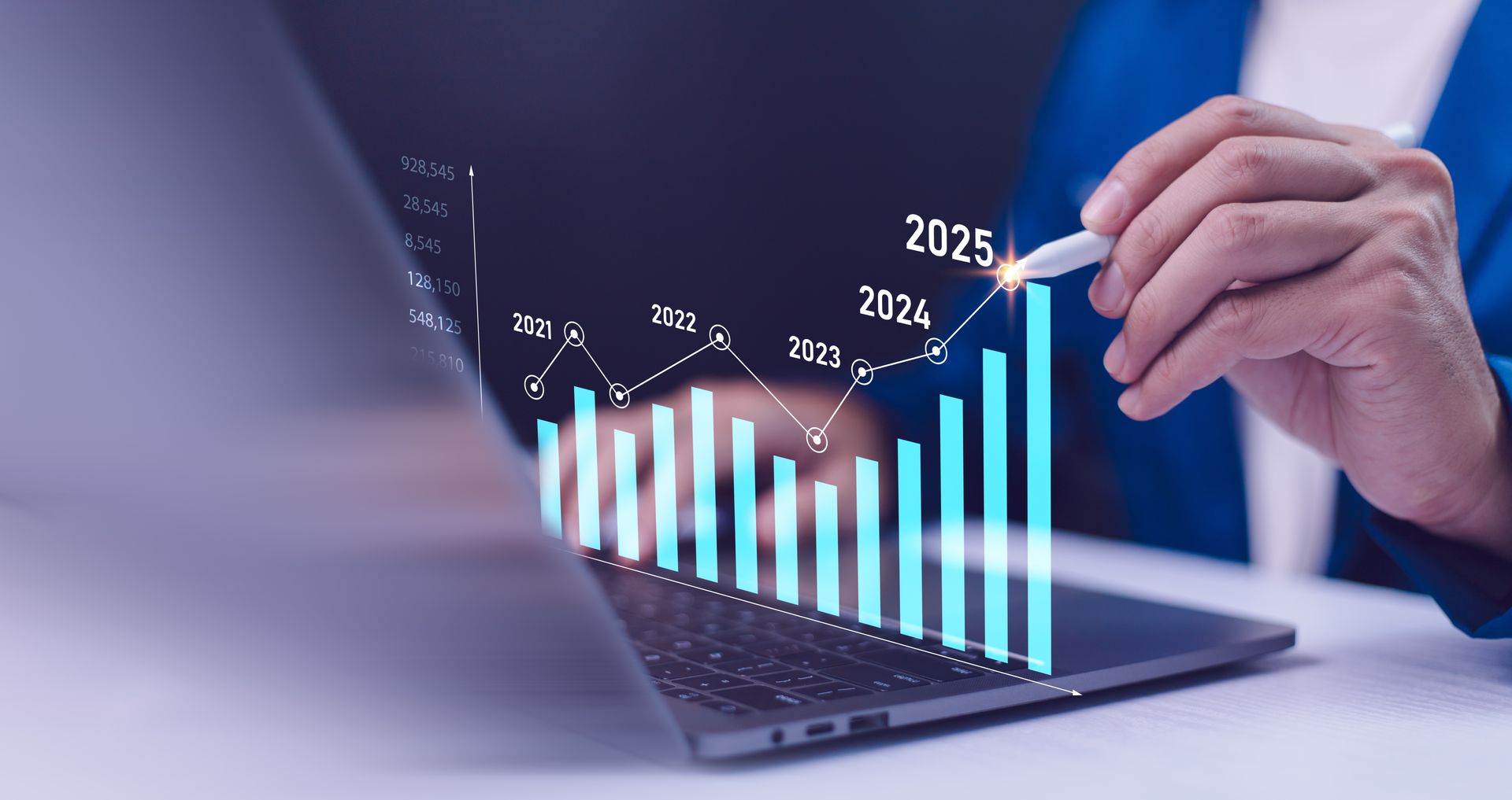 A person is pointing at a graph on a laptop computer.