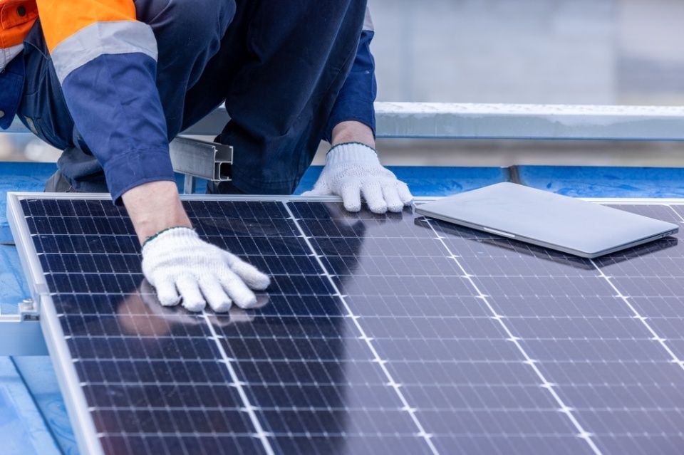 two men installing solar panels