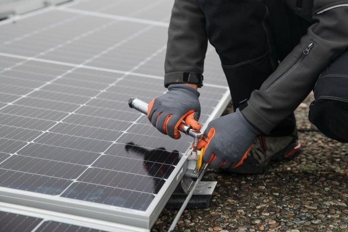 Technician is repairing solar panel