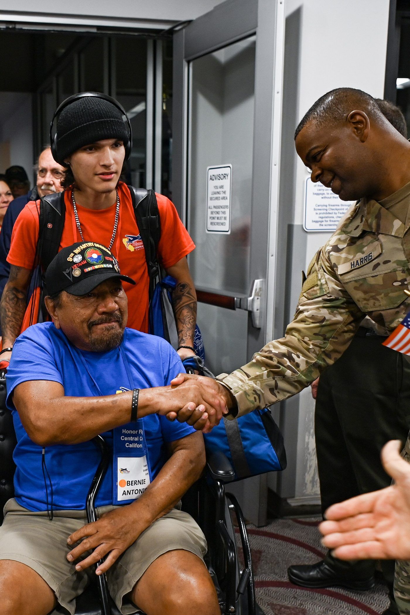 A United States service member welcoming home veterans arriving on an Honor Flight