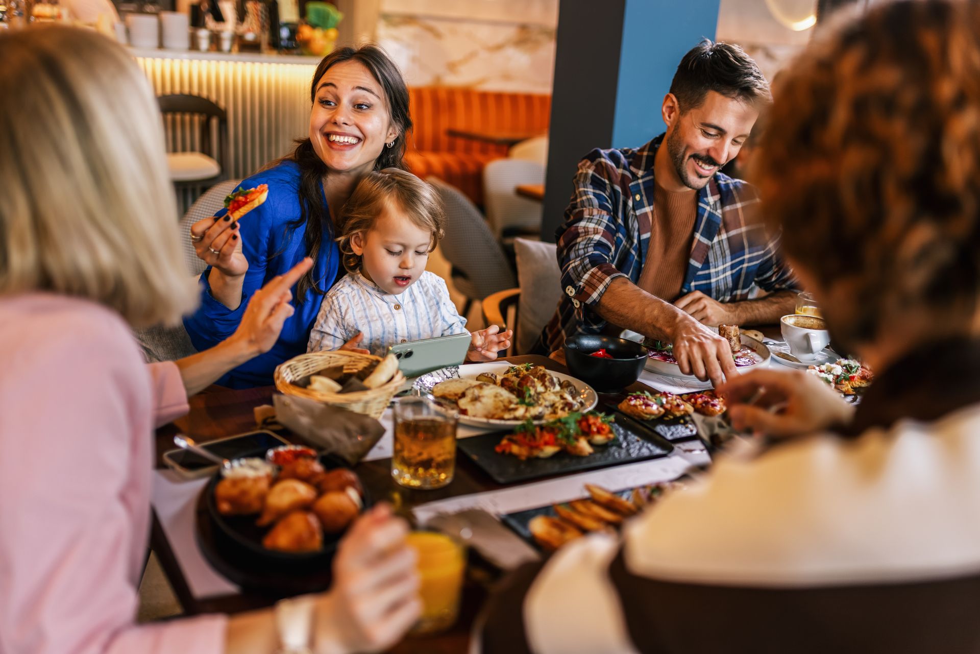 Guests sharing Korean BBQ around a tabletop grill