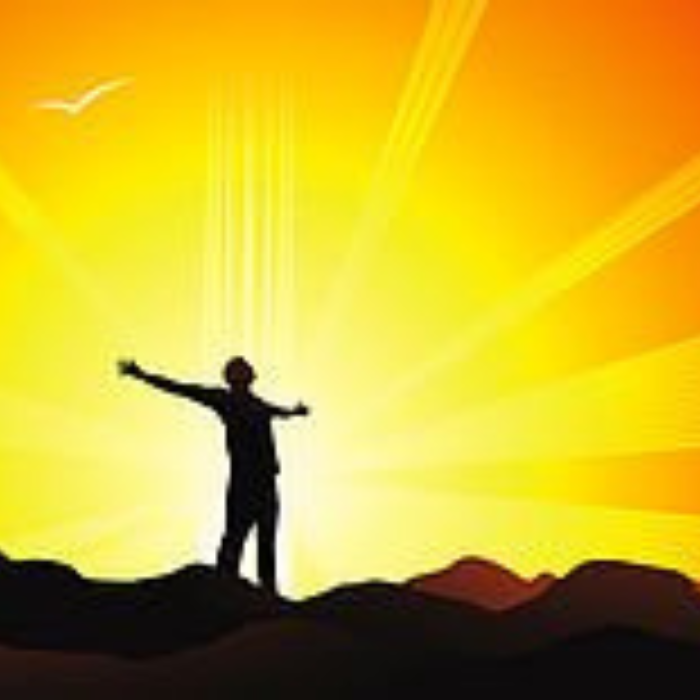 Silhouette of a person with arms outstretched towards a bright sun, standing on a hill; yellow and orange colors.