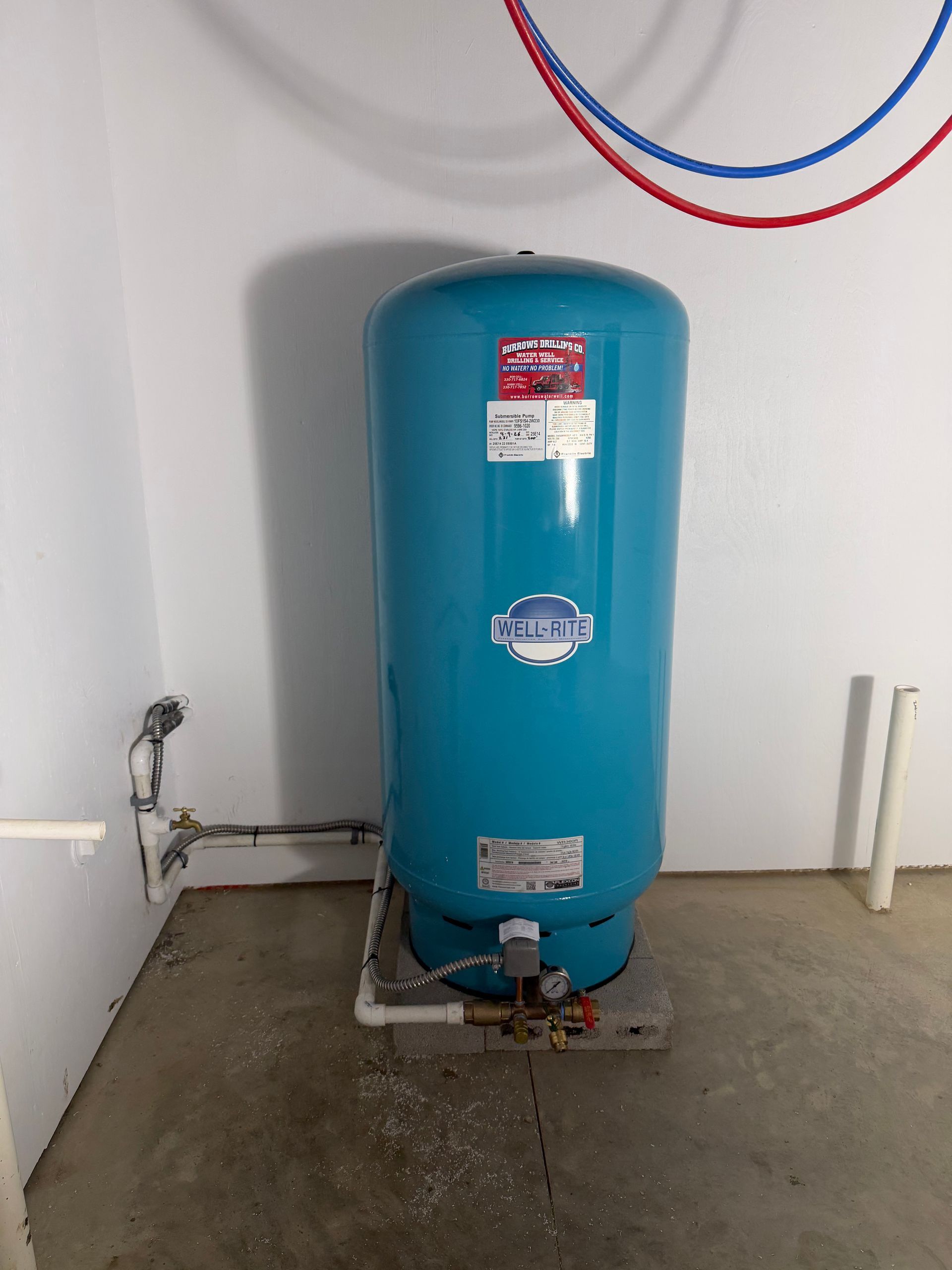A large pressure tank for extra water storage for a residential house.