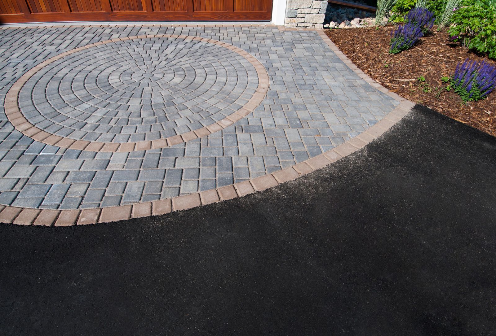 A driveway with a circular design in the middle