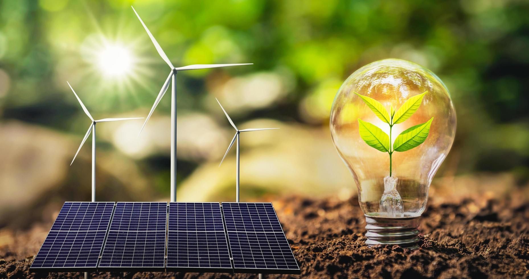 Une ampoule avec une plante à l'intérieur à côté d'un panneau solaire et d'éoliennes.