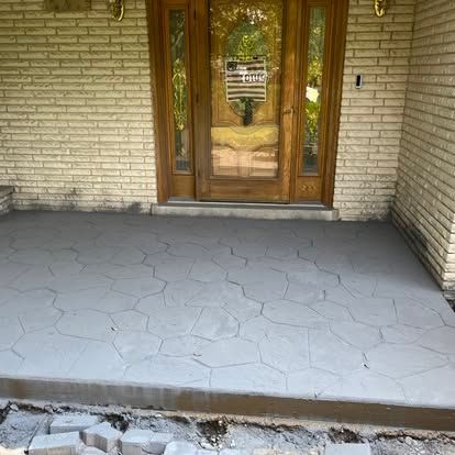 Newly poured concrete porch with stone-like pattern, in front of a brick building. Newly poured concrete porch with stone-like pattern, in front of a brick building.