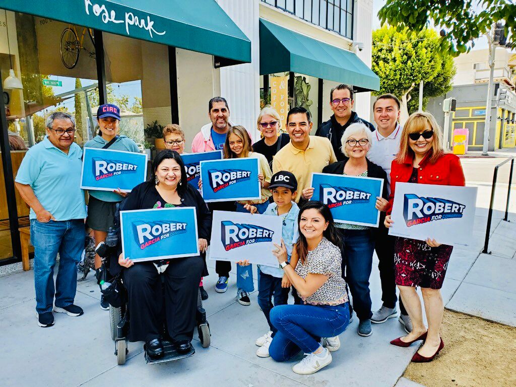 A group of people are holding signs that say robert.