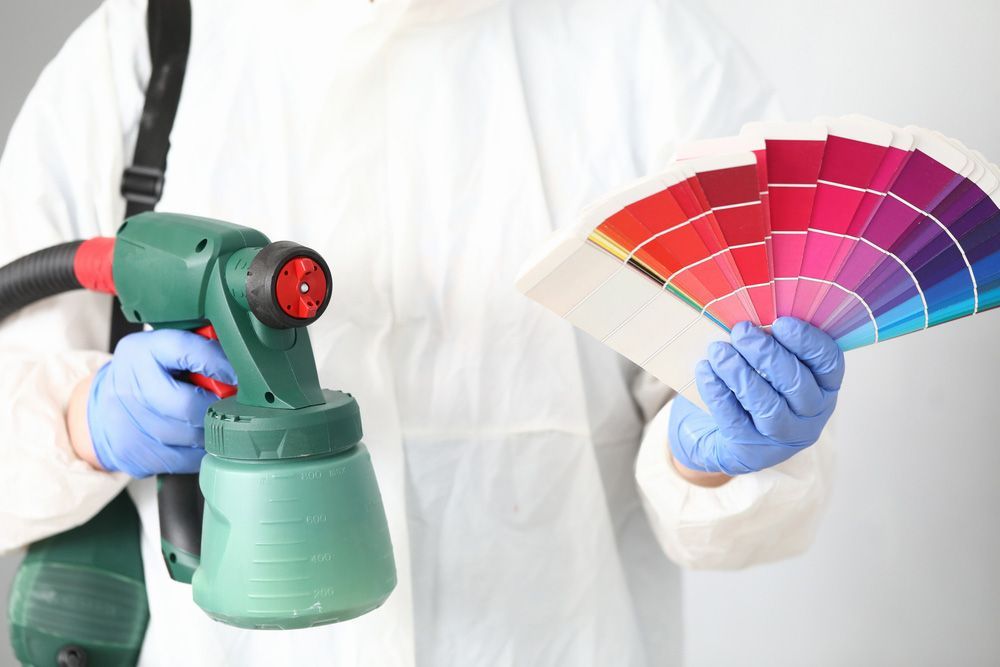 Man Holds In His Hands Spray Gun And Palette Of Colours — Paint Colour Matching in Tamworth, NSW