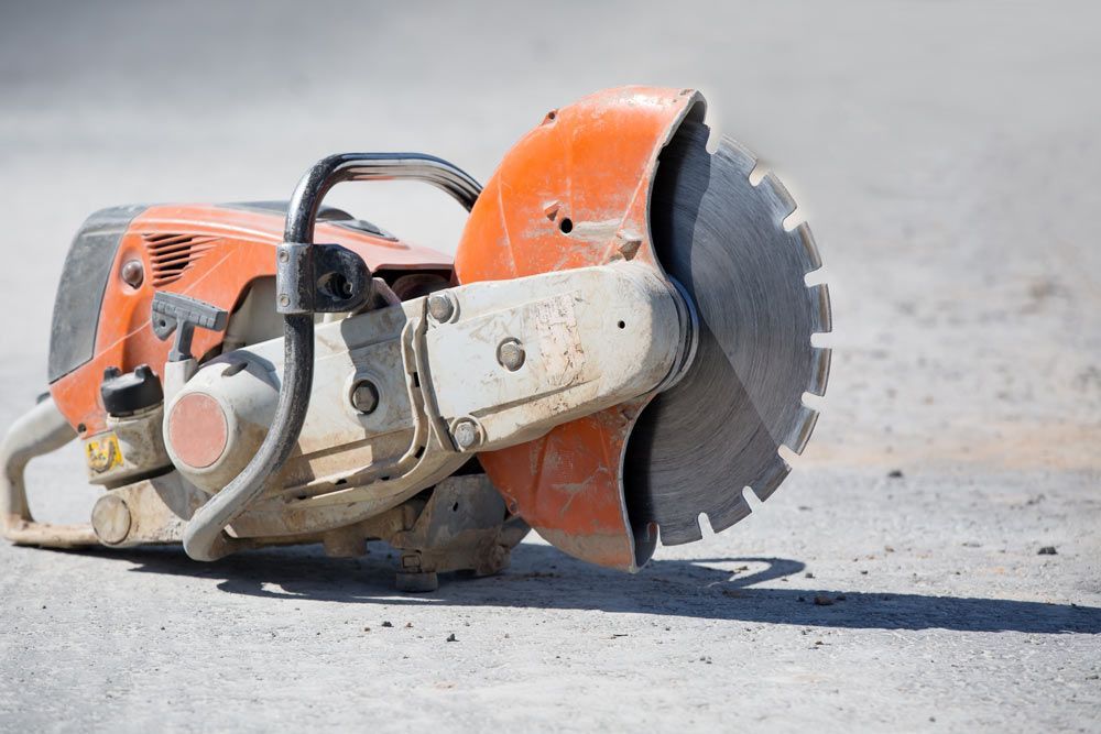 Concrete Gasoline Saw Grinder At Construction Site — Top-Quality Building Supplies in Tamworth, NSW